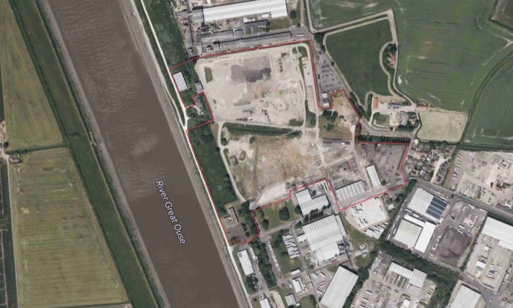 Aerial map with red line showing outer perimeter of site
