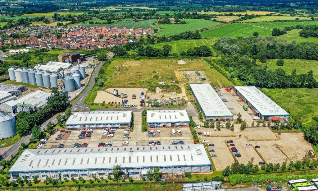 Oblique aerial photo of site showing several large industrial buildings