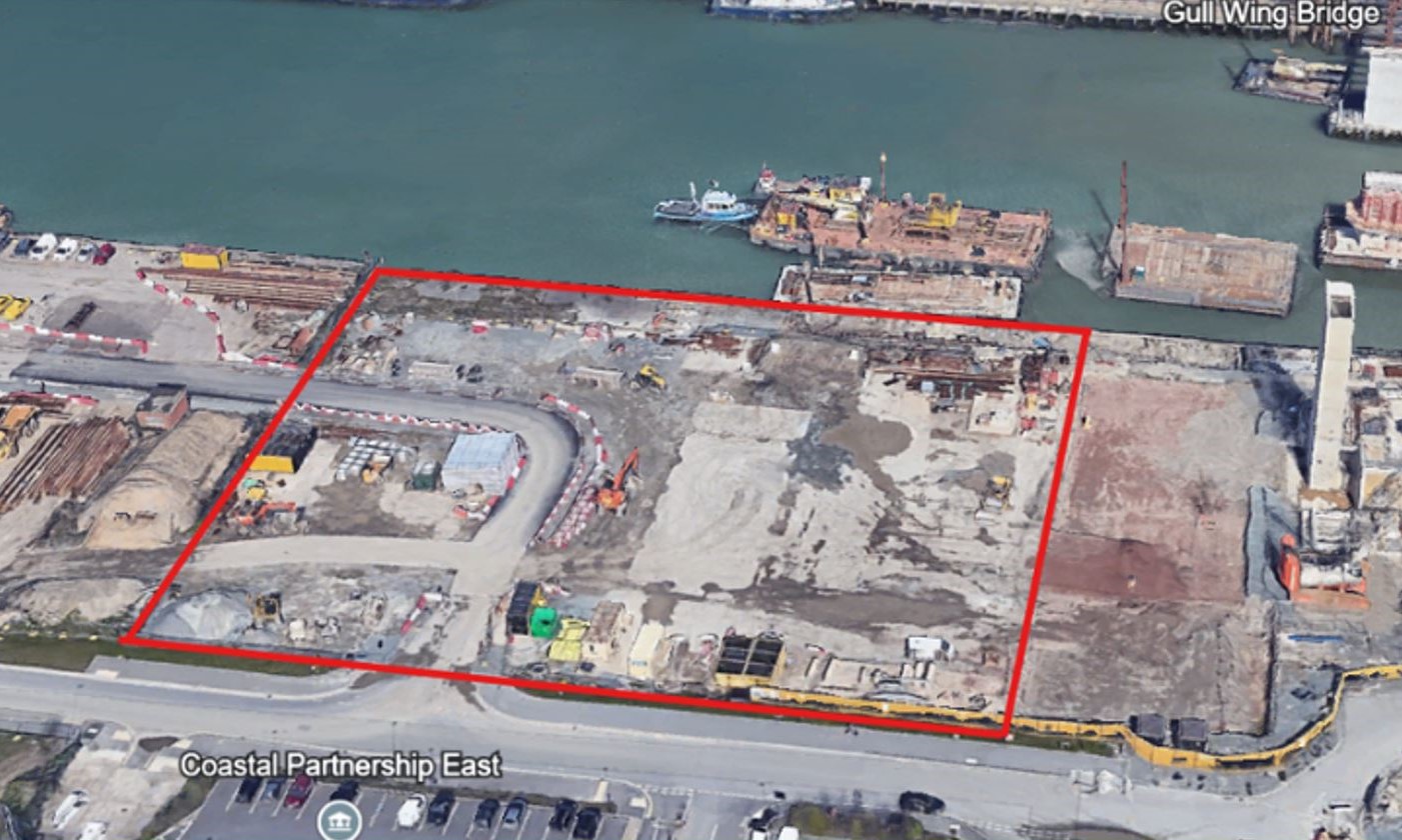 Aerial map with red line showing outer perimeter of site