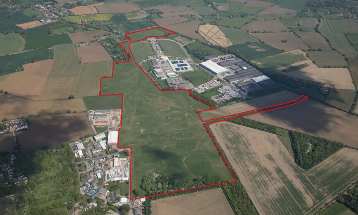 Aerial view of site. Area of fields with outer boundary marked in red