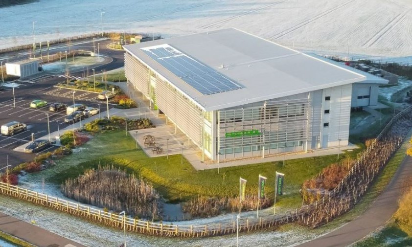 Aerial photo with overlaid image of industrial building