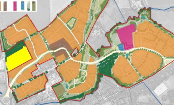 Oblique aerial photo of site including a large building surrounded by a carpark, with perimeter of area outlined in orange